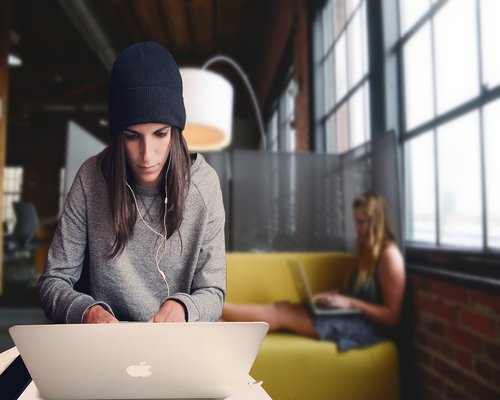 Modern open space coworking facility with plants and blurred people working